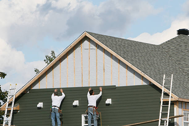 Professional Storm Damage Siding Repair technician working in Chester, WV